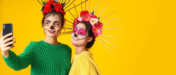 Women Painted Skull Faces Taking Selfie Yellow Background Space Text — Stock Photo, Image