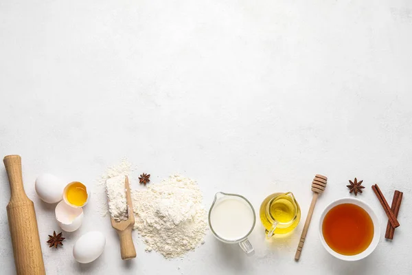 Set of different ingredients for baking on light background