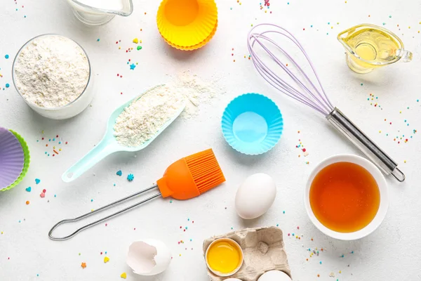 Composition with ingredients for baking pastry and utensils on light background