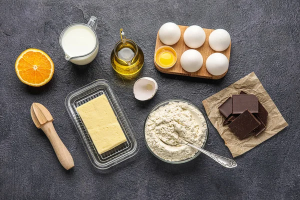 Different ingredients for baking on dark background