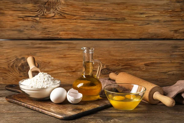 Different ingredients for baking against wooden background
