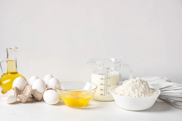 Different ingredients for baking on table against white background