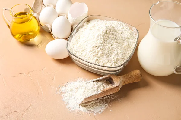 Different ingredients for baking on beige table