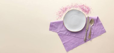 Table setting and scattered sea salt on light background with space for text