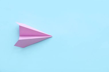 Lilac paper plane on blue background