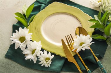 Elegant table setting with chamomile flowers on white and green background