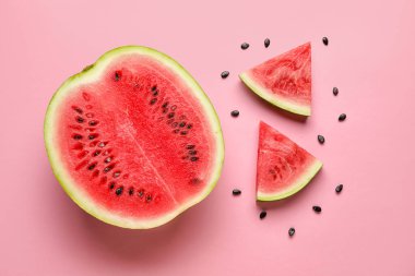 Slices of tasty watermelon with seeds on pink background