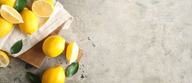 Fresh ripe lemons on grunge background with space for text