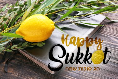 Greeting card with Sukkot festival symbols and Bible on wooden background