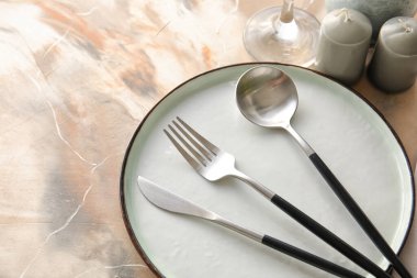 Table setting with candles on light background