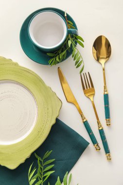 Elegant table setting with plant branches on light background