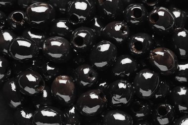Delicious black olives as background, closeup