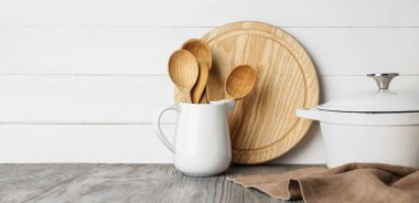 Set of kitchen utensils on table against light background  