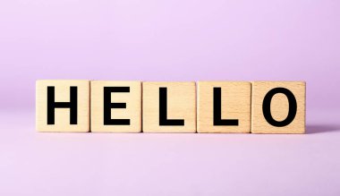 Word HELLO made of cubes on lilac background