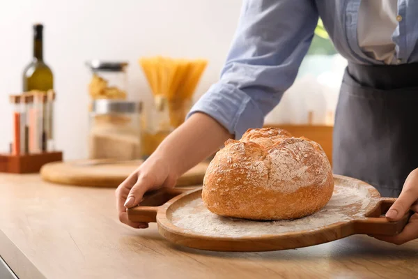 Woman Putting Board Fresh Bread Table Kitchen Closeup — Stock Fotó