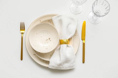 Beautiful table setting with plates, cutlery and glasses on white background