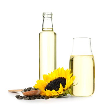 Bottles of oil, seeds and sunflower isolated on white background