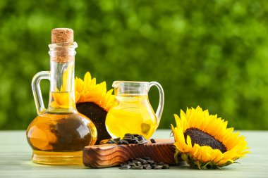 Decanter and jug of sunflower oil on table outdoors