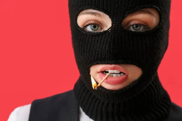 Portrait Young Woman Balaclava Burning Match Mouth Red Background — Stock Photo, Image