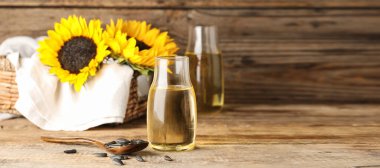 Bottle with sunflower oil on wooden table