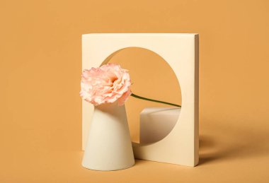 Decorative plaster podiums with eustoma flower on color background