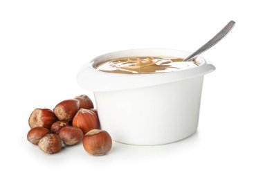 Bowl with delicious hazelnut butter on white background