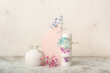 Plaster podiums and gypsophila flowers on light table