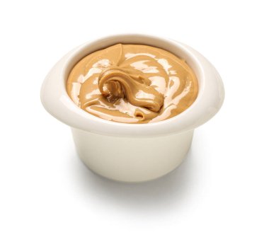 Bowl of delicious nut butter on white background