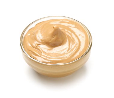 Bowl of tasty nut butter on white background