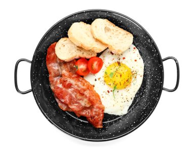 Frying pan with tasty fried egg, bacon and bread on white background