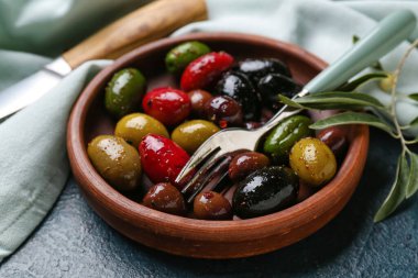 Plate with delicious olives on table, closeup