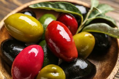 Plate with different kinds of tasty olives, closeup