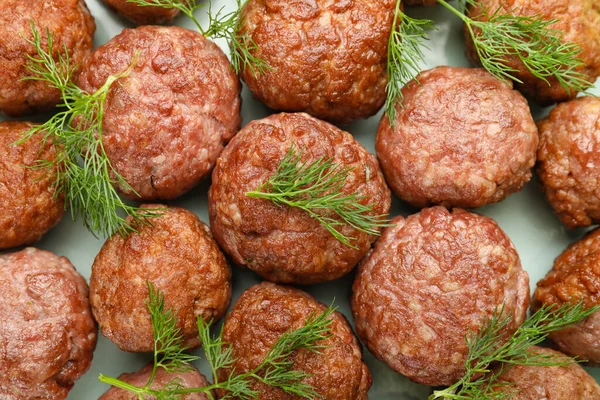 Tasty meat balls with dill on plate, closeup