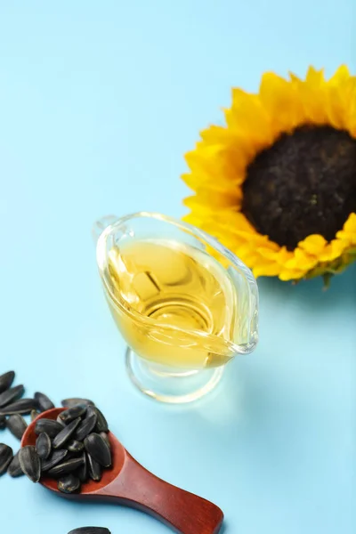 Gravy boat of sunflower oil on color background
