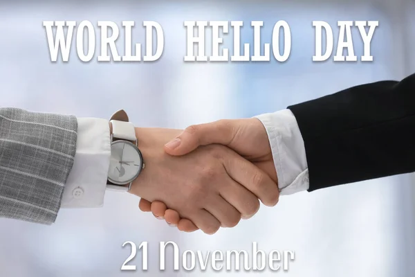 Businessmen handshaking. World Hello Day