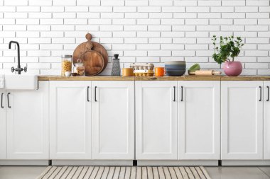 Interior of light kitchen with white counters and food