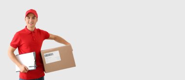Handsome delivery man with parcel on light background with space for text