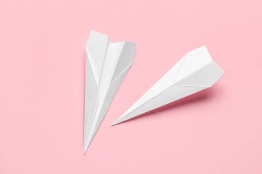 Paper planes on pink background