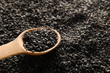Wooden spoon with black sesame, closeup