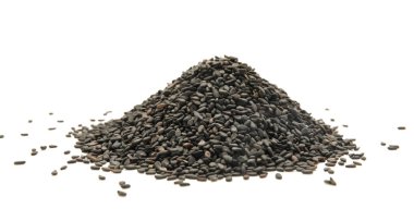 Beyaz arkaplanda siyah susam tohumları yığını