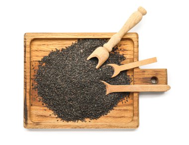 Wooden board with black sesame seeds on white background