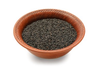 Bowl of black sesame seeds isolated on white background