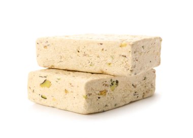 Pieces of delicious sesame halva on white background