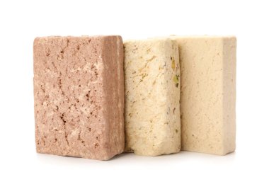 Pieces of tasty sesame halva on white background