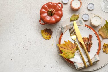 Beautiful table setting with autumn decor and candles on light background