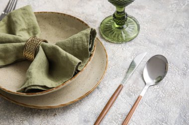 Closeup view of elegant dinnerware on grey table