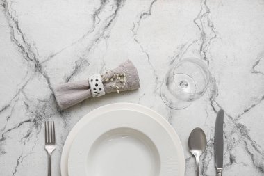 Simple table setting on white marble background