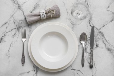 Simple table setting on white marble background