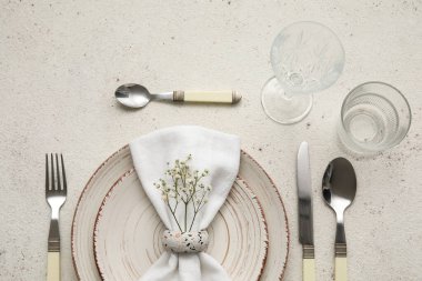 Elegant table setting with gypsophila flowers on light background