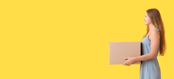 Young Woman Cardboard Box Yellow Background Space Text — Stockfoto